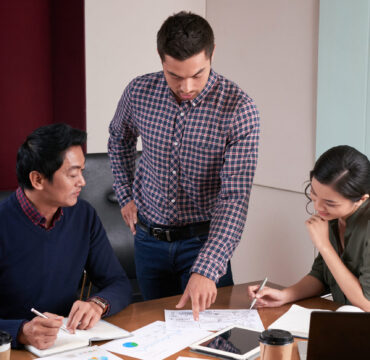 Businessman showing report he made to coworkers