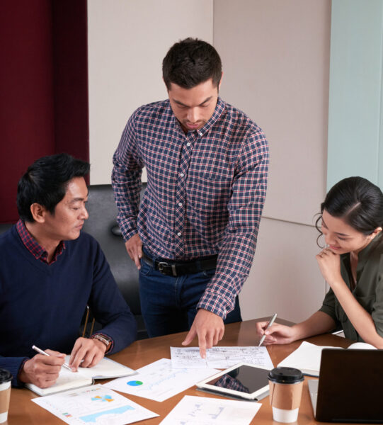 Businessman showing report he made to coworkers