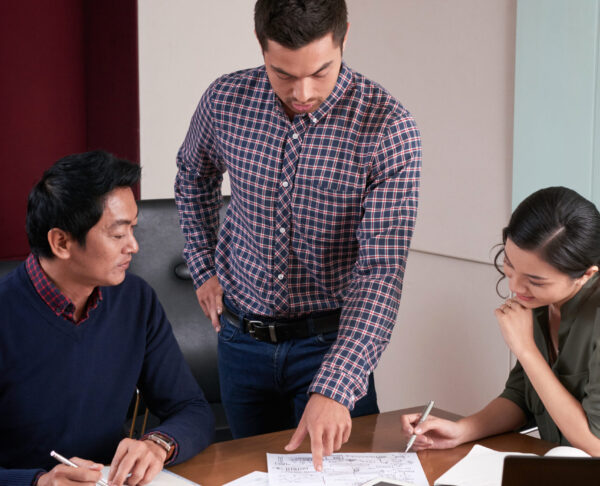 Businessman showing report he made to coworkers